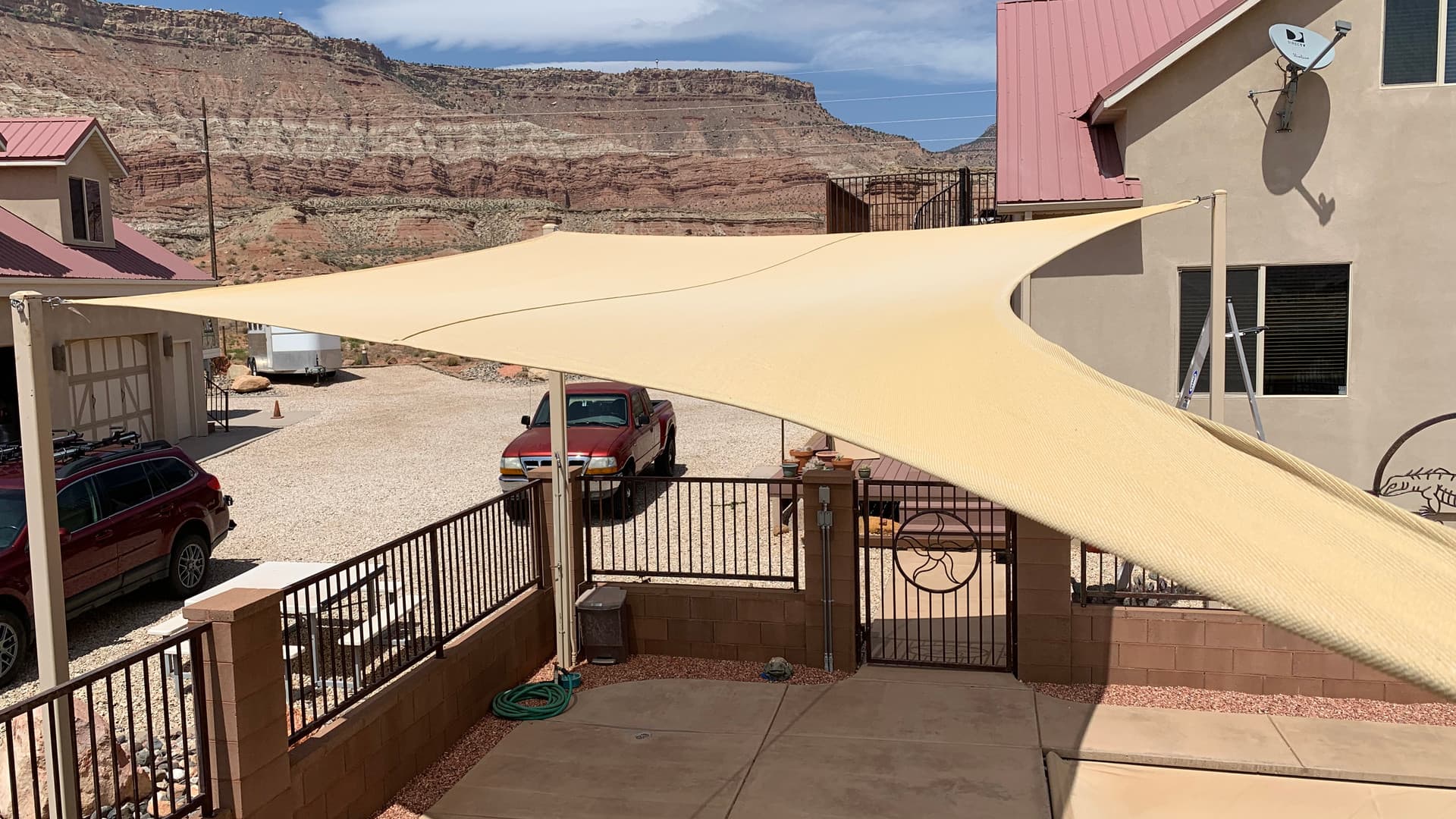 Commercial shade sail installation with red rock backdrop