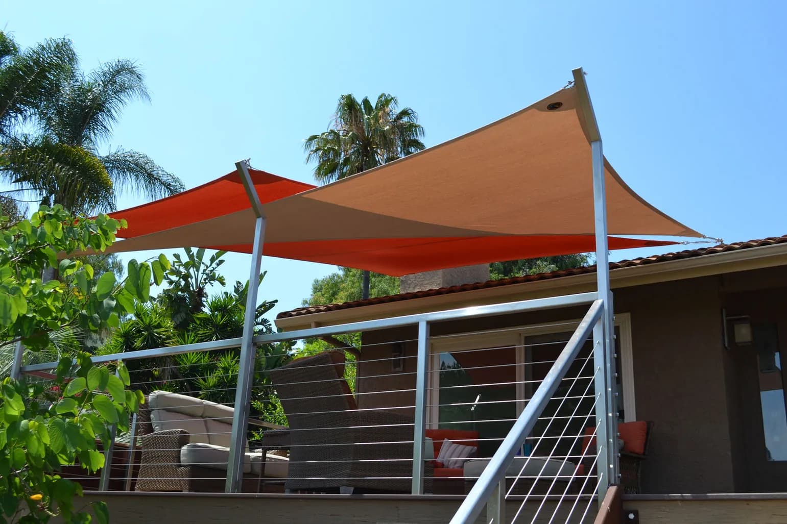 Custom red and tan shade sails over an Arizona residential outdoor deck