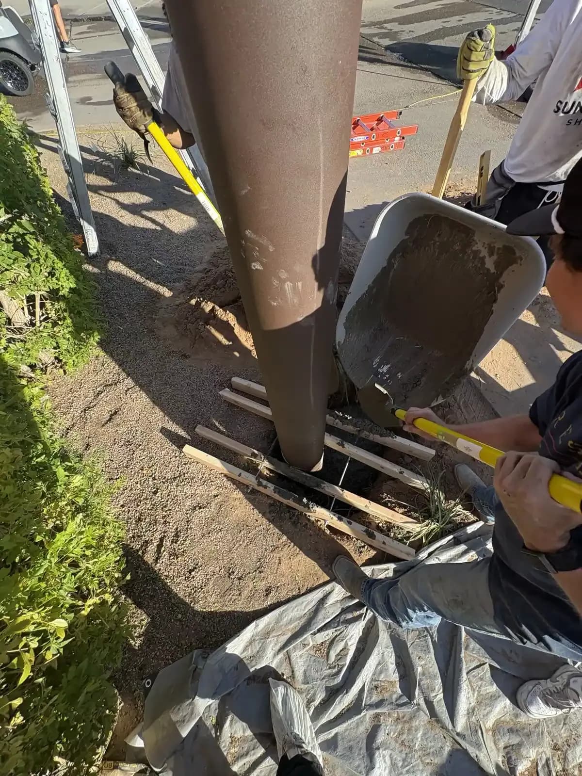 Apex crew installing a shade sail structure on site