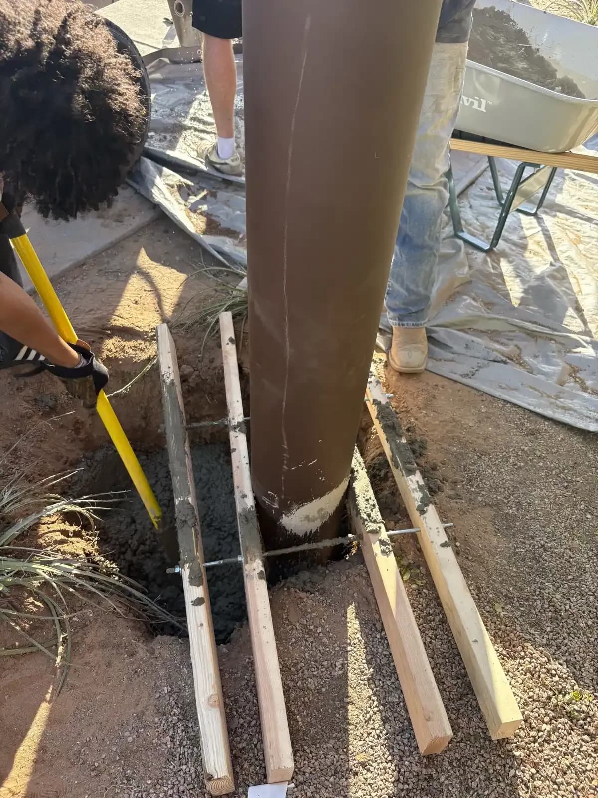 Apex crew installing a shade sail structure on site