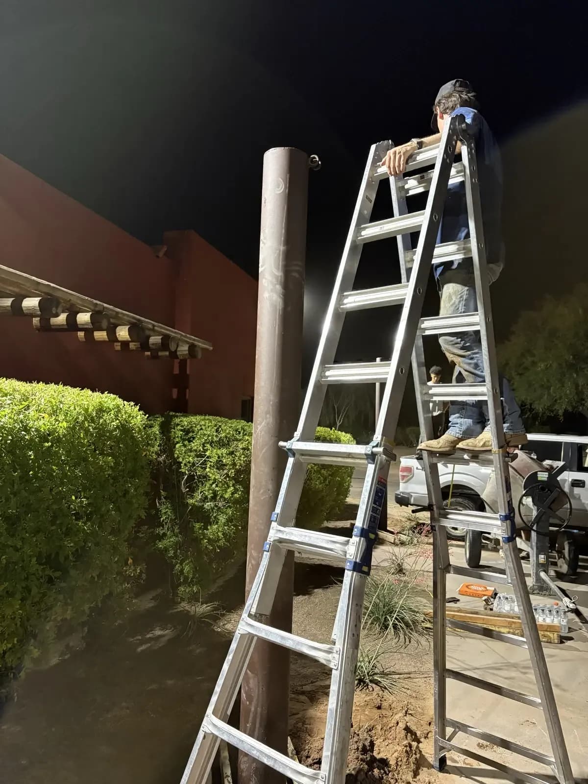 Apex crew installing a shade sail structure on site