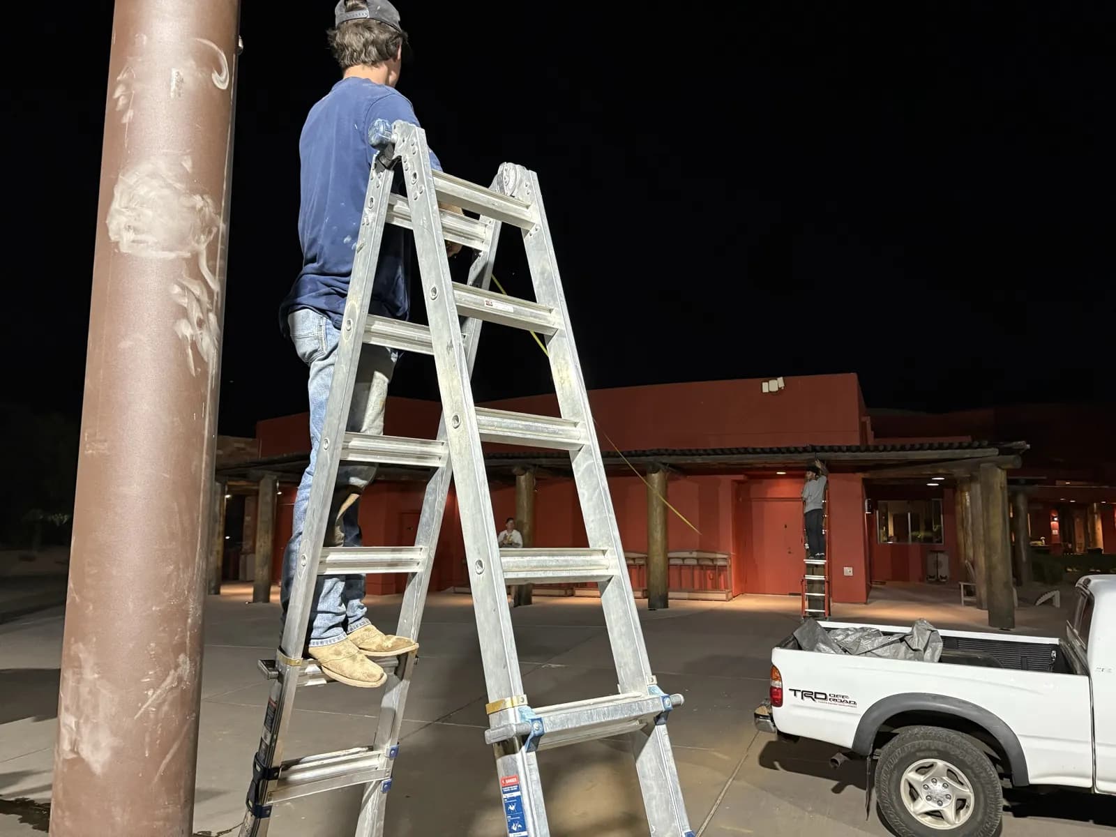 Apex crew installing a shade sail structure on site