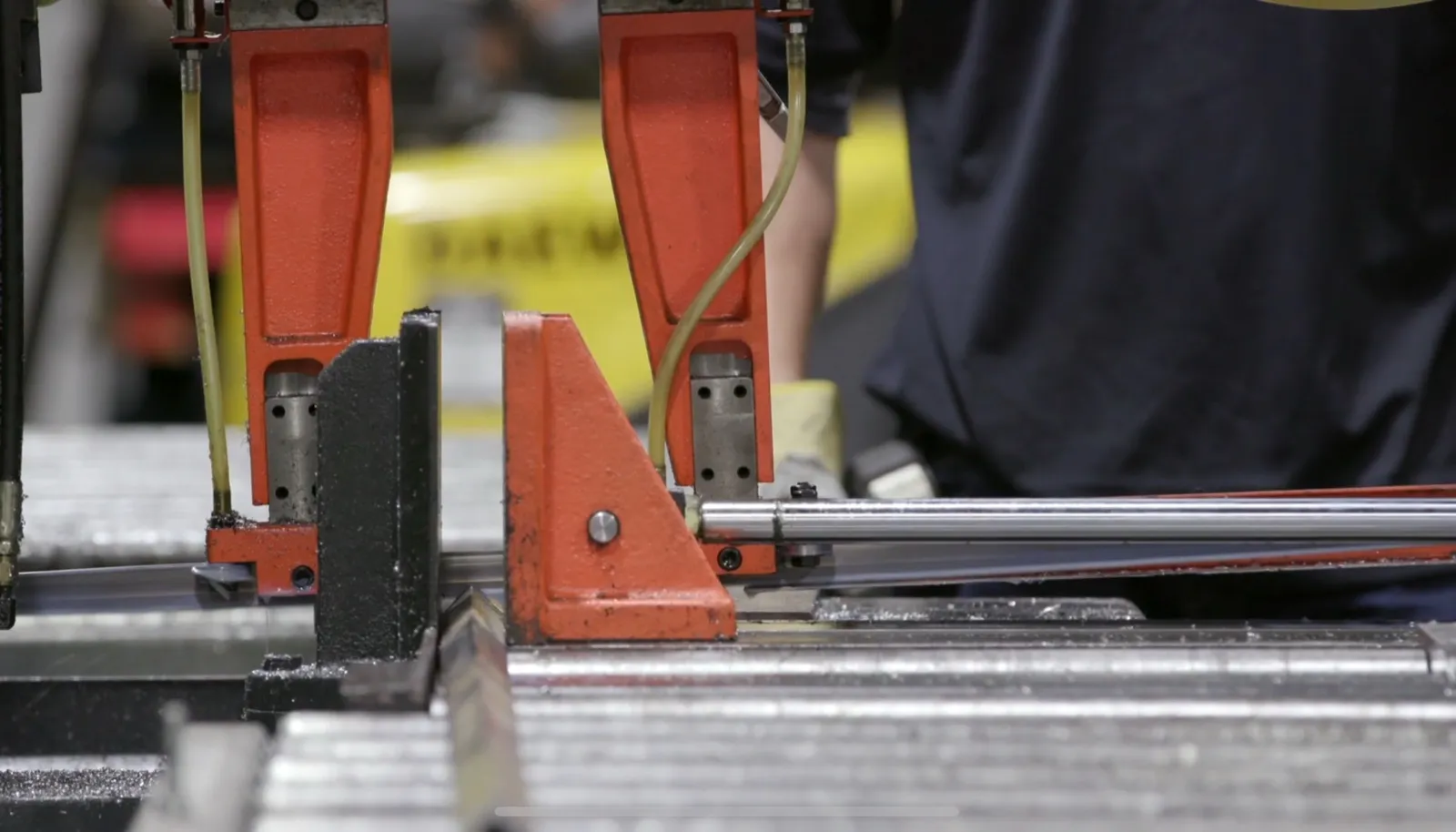 Structural steel post being cut to length on a clamped cutting saw