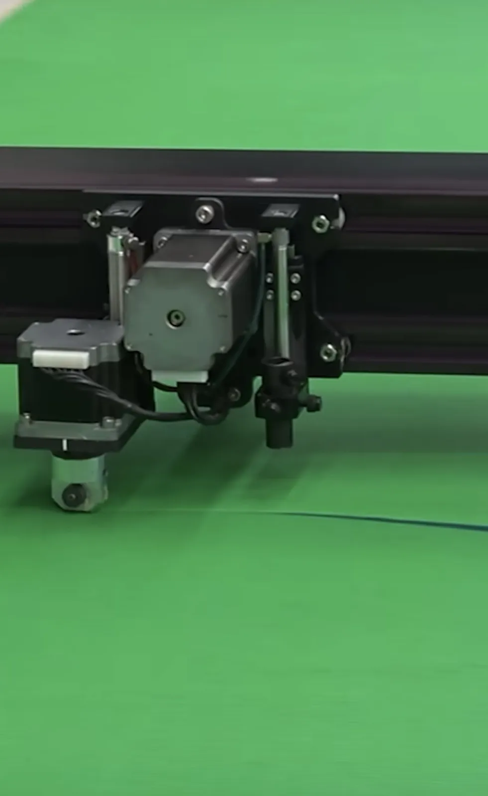 Automated cutting head trimming shade fabric on the cutting table